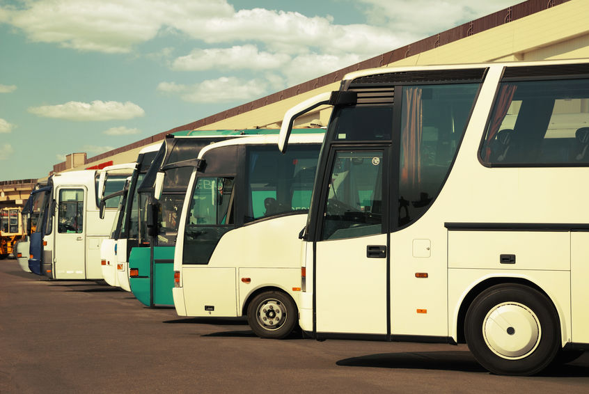 buses at charter bus company with cloudy sky