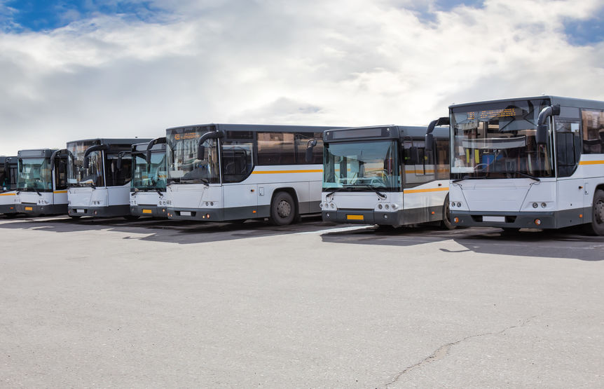 big tourist buses on parking on the background of cloudy sky